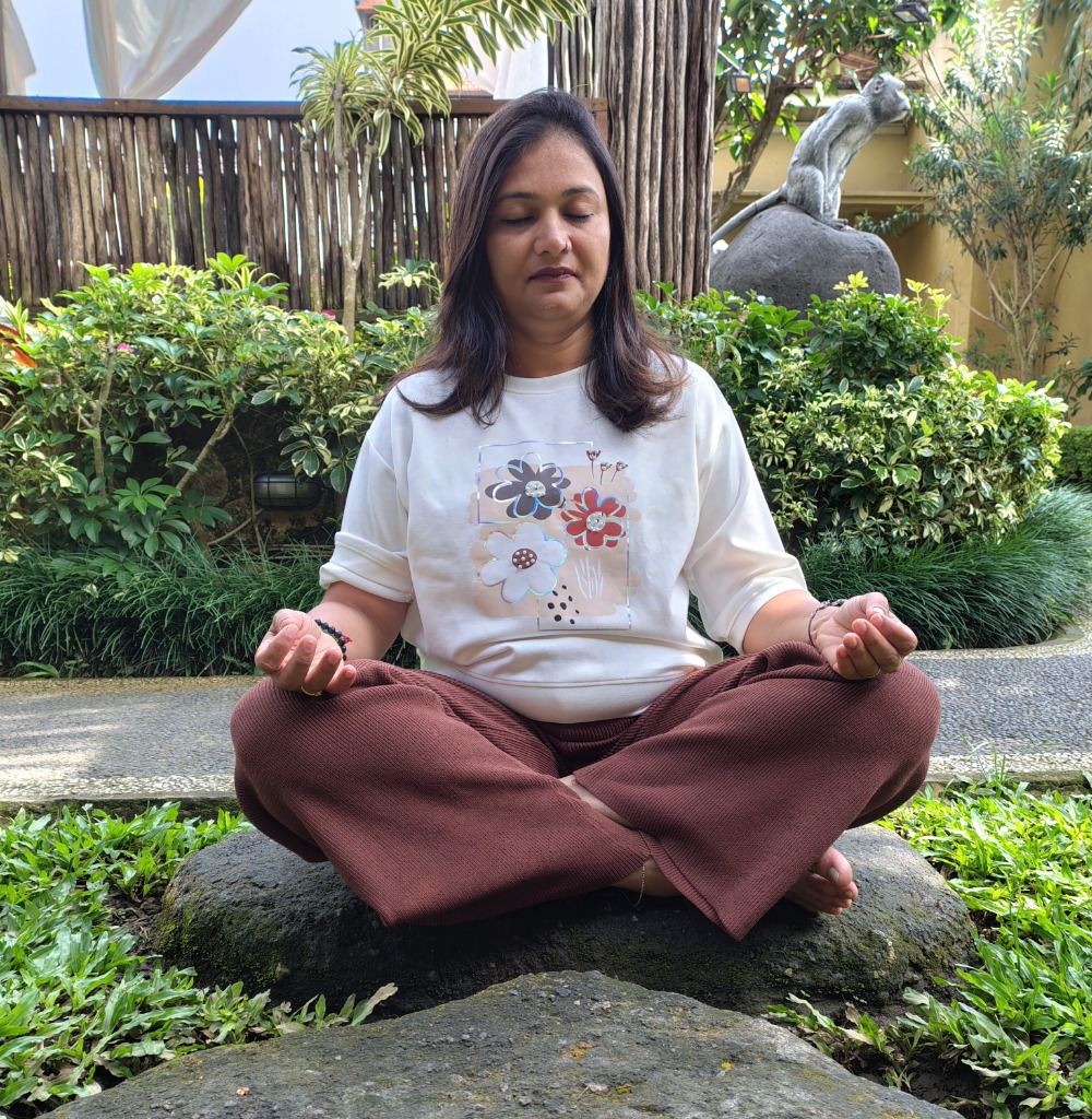 Woman meditating outdoors at sunset